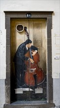 Colourful painted door with musician playing double bass