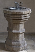 Historic 16th century baptismal font with baptismal font