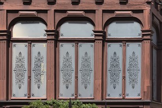 Glazed veranda with ornate panes of a historic villa