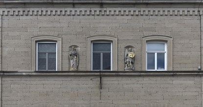 Sculptures of saints on the facade of a 19th century house