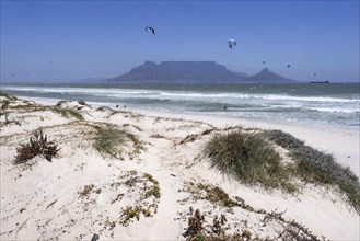 Table Mountain and white sandy beach at Bloubergstrand along the Atlantic Ocean at Table Bay near Cape Town
