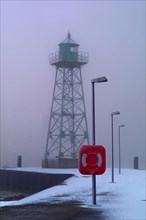 Lighthouse at the mouth of the river Geese in Bremerhaven in the fog
