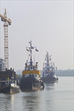 Tugboat and launch at a shipyard pier