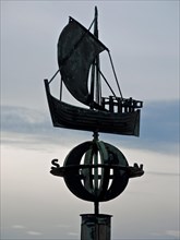 Stylised sculpture of a Hanseatic cog on the Weser promenade in Bremerhaven