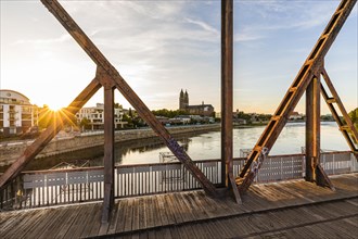 Historic lift bridge and Magdeburg Cathedral at sunset