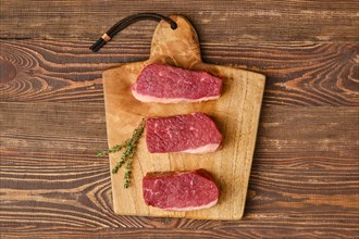 Top view of raw fresh eye of round steak on cutting board