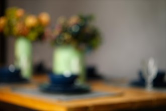 Defocused photo of empty table served for dinner. Abstract bokeh