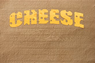 Title cheese on cardboard background