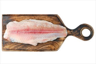 Top view of fresh raw fillet of pangasius on wooden cutting board isolated on white background