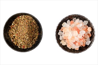 Top view of saucers with pepper and himalayan salt isolated on white
