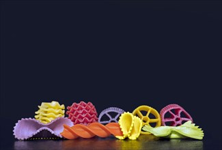 Colourful pasta in different shapes