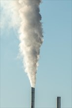Column with smoke coming out of an industrial chimney. France