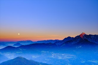 The peaks of Hoher Dachstein and hoher Goell in the last evening light and moonrise
