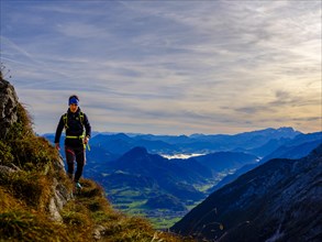 Mountaineer walking on a narrow path above the Salzach valley