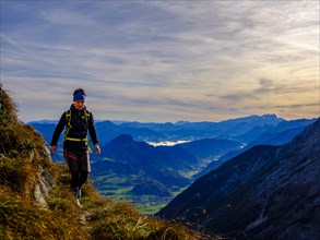 Mountaineer walking on a narrow path above the Salzach valley