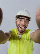 Funny builder engineer taking a selfie isolated