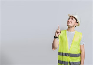 Builder engineer pointing finger to the right isolated