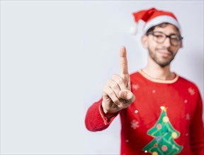 Man in christmas hat counting number one with finger. Man in christmas costume counting number one with finger. Concept of man in christmas costume counting number one isolated