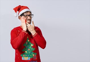 Man in christmas sweater with toothache