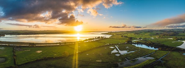 Sunrise over Wetlands and meadows in RSPB Exminster and Powderham Marshe from a drone