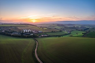 Sunset over fields and Widdicombe Farm from a drone