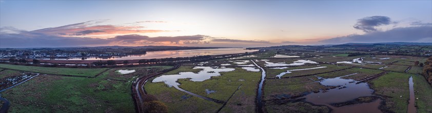 Sunrise over Wetlands and meadows in RSPB Exminster and Powderham Marshe from a drone