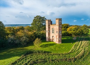 The Belvedere Tower over Powderham Park from a drone in Autumn Colors