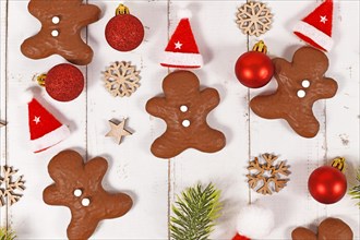 Gingerbread glazed with cocolate in shape of men between Christmas decoration