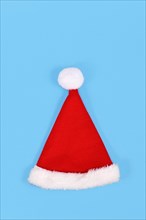 Red Santa hat on blue background