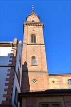 Clock tower of catholic St. Laurentius church in Weinheim city in Germany in front of blue sky
