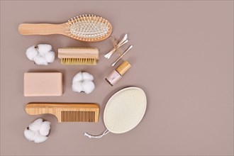 Eco friendly wooden beauty and hygiene products like comb and soap on gray background with copy space