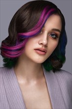 Portrait of beautiful woman with multi-colored hair and classic make up and hairstyle