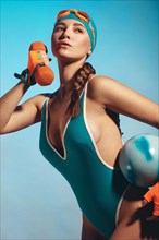 Beautiful attractive woman in a trendy swimsuit with sports equipment and accessories. Fashion photo session. beauty face