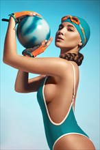 Beautiful attractive woman in a trendy swimsuit with sports equipment and accessories. Fashion photo session. beauty face