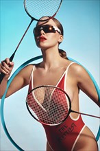 Beautiful attractive woman in a trendy swimsuit with sports equipment and accessories. Fashion photo session. beauty face
