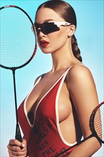 Beautiful attractive woman in a trendy swimsuit with sports equipment and accessories. Fashion photo session. beauty face