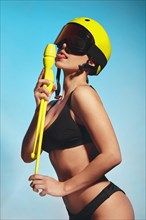 Beautiful attractive woman in a trendy swimsuit with sports equipment and accessories. Fashion photo session. beauty face