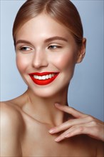 Beautiful girl with red lips and classic makeup. Beauty face. Photo taken in the studio
