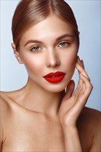 Beautiful girl with red lips and classic makeup. Beauty face. Photo taken in the studio