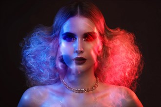 Portrait of a beautiful woman with bright evening makeup and colored filters. Beauty face