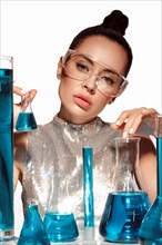 Beautiful woman with laboratory containers with liquid