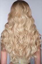 A closeup view of a bunch of shiny curls blond hair