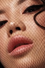 Portrait of beautiful asian woman with mesh on face and makeup. Beauty face. Close-up