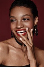 Beautiful black woman with a smile and red lips and freckles. Beauty face. Photo taken in the studio