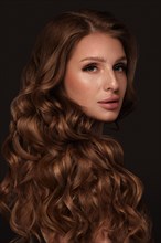 Beautiful brown-haired girl with a perfectly curls hair