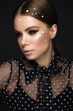 Portrait of a beautiful woman in a black dress with pearls and classic makeup. Beauty face