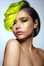 Portrait of beautiful woman with multi-colored hair and creative make up and hairstyle