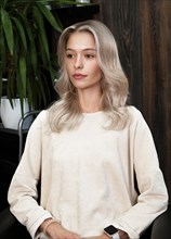 Young woman in a hairdressing salon dyes her hair blond. beauty face and hair