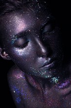 Girl with art space makeup. Glitter face