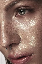 Portrait of beautiful woman with art glitter makeup on her face